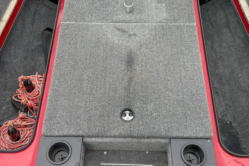 Slide: The Image of 2023 Tracker Pro Team 175 TXW Tournament Edition boat deck with storage and cup holders. - 12