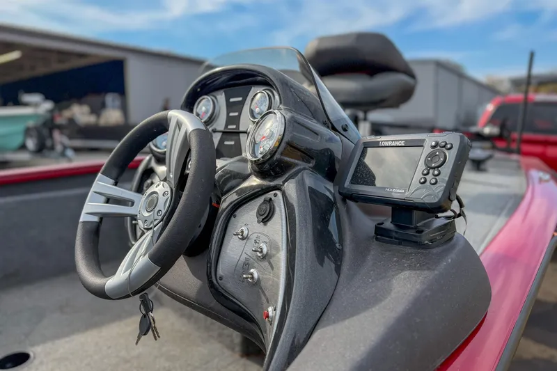 Slide: The Image of 2023 Tracker Pro Team 175 TXW Tournament Edition boat dashboard with steering wheel and Lowrance fishfinder. - 3