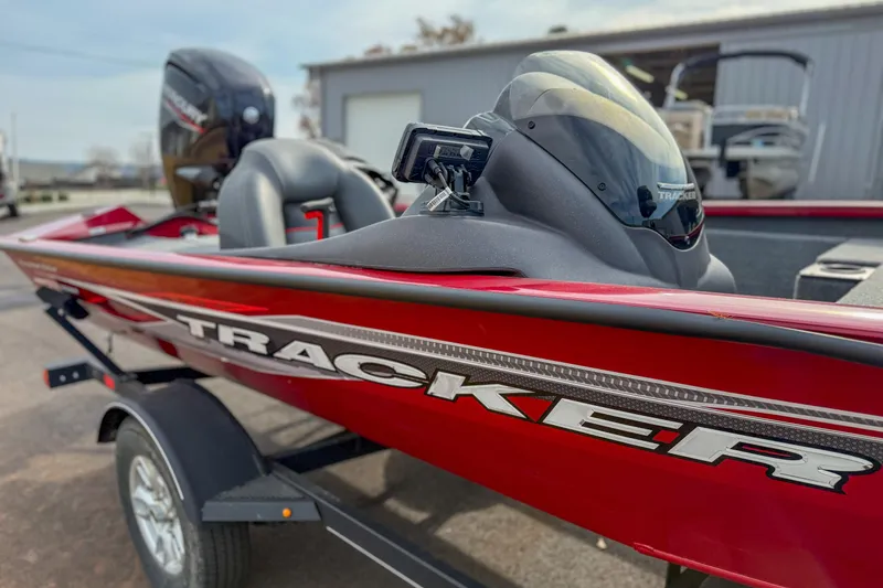 Slide: The Image of 2023 Tracker Pro Team 175 TXW Tournament Edition boat, red exterior, parked on trailer. - 6