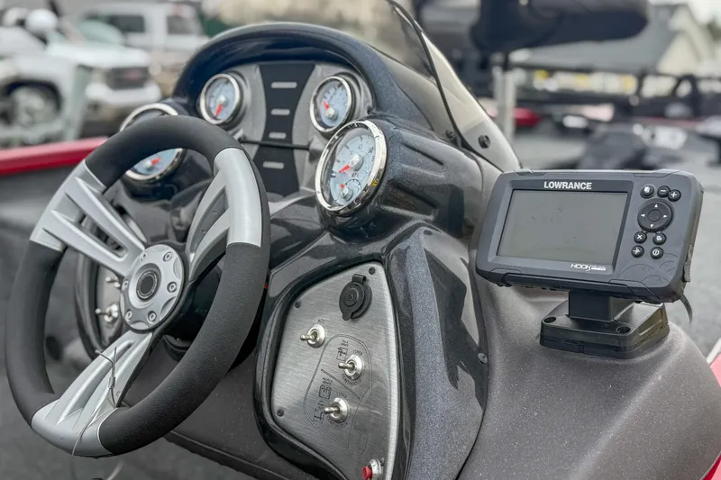 Slide: The Image of 2023 Tracker Pro Team 175 TXW Tournament Edition dashboard with steering wheel and Lowrance fish finder. - 7