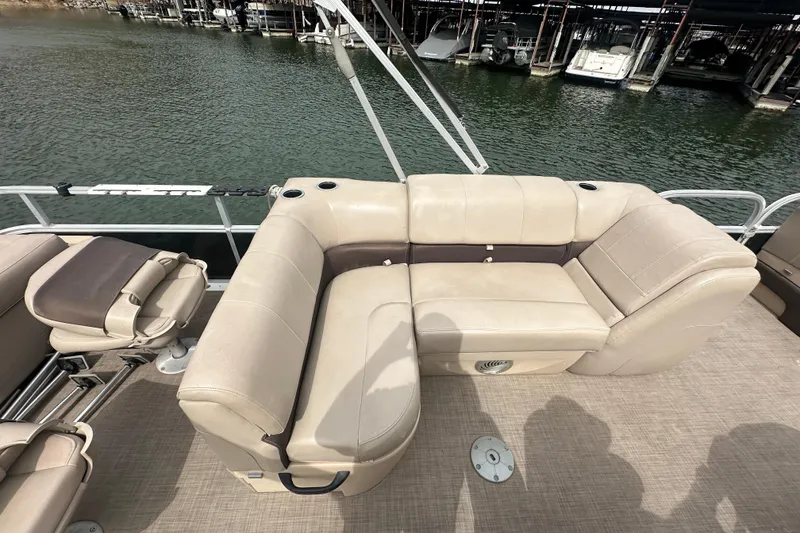 Slide: The Image of 2019 SunCatcher SF 22 XP3 pontoon boat with beige seating, docked by the water. - 13