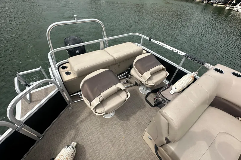 Slide: The Image of 2019 SunCatcher SF 22 XP3 pontoon boat interior with seating and fishing rod holders. - 14