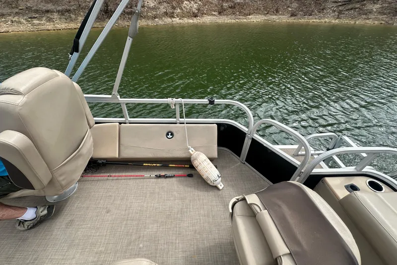 Slide: The Image of 2019 SunCatcher SF 22 XP3 pontoon boat interior with fishing rod and lake view. - 15
