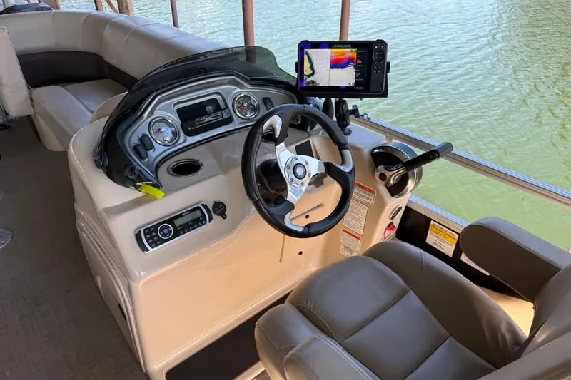 Slide: The Image of 2019 SunCatcher SF 22 XP3 boat dashboard with steering wheel and navigation system. - 16