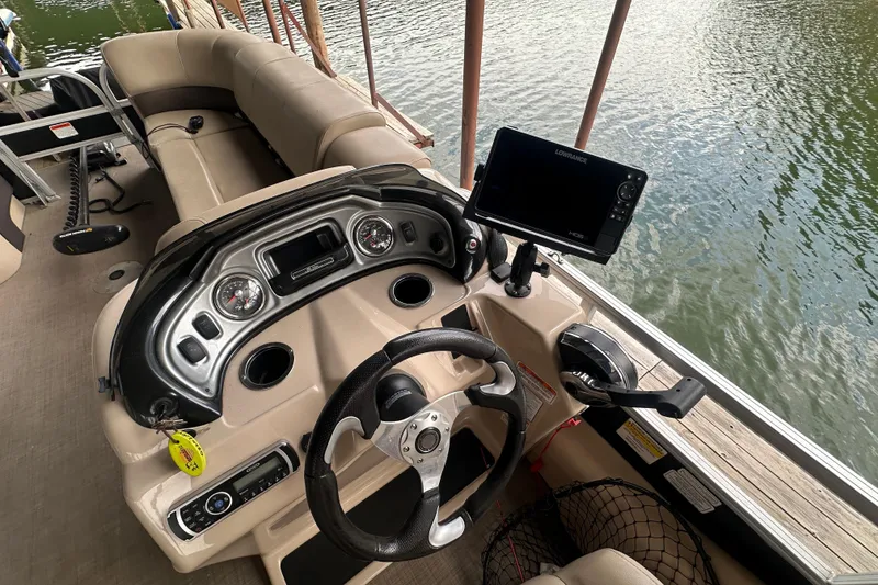 Slide: The Image of 2019 SunCatcher SF 22 XP3 boat dashboard with steering wheel and navigation system. - 20