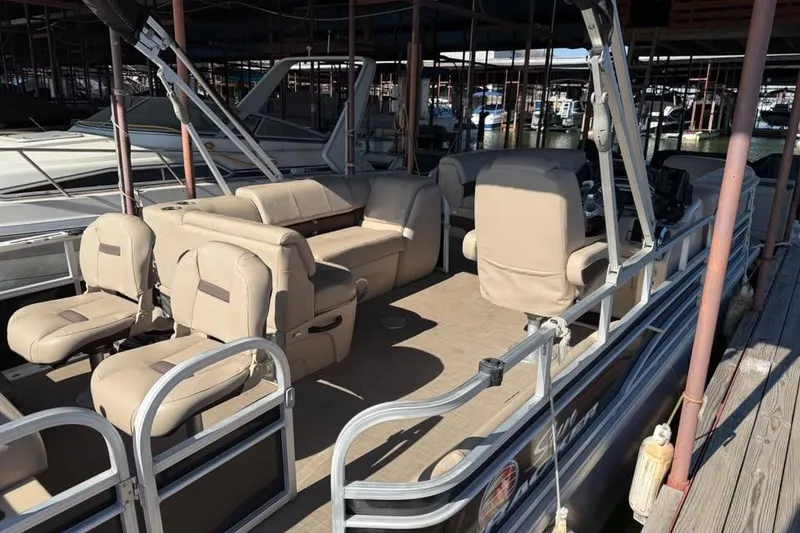Slide: The Image of 2019 SunCatcher SF 22 XP3 pontoon boat with beige seating, docked in a marina. - 21