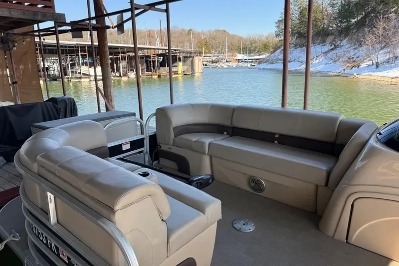 Slide: The Image of 2019 SunCatcher SF 22 XP3 pontoon boat with beige seating, docked by a scenic lake. - 25