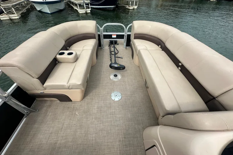 Slide: The Image of 2019 SunCatcher SF 22 XP3 pontoon boat interior with beige seating and cup holders. - 7
