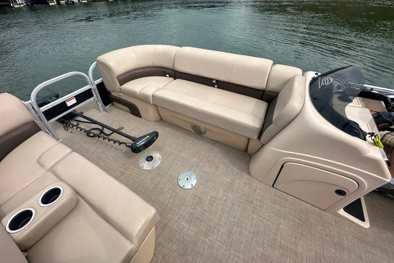 Slide: The Image of 2019 SunCatcher SF 22 XP3 pontoon boat interior with beige seating and water view. - 9