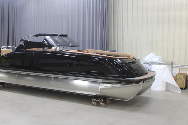 The Image of 2026 Harris Crowne SL 250 pontoon boat in a showroom setting. - 0