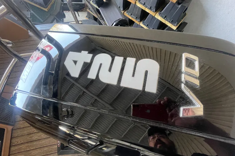 Slide: The Image of 2026 Harris Crowne SL 250 boat with Mercury engine, reflecting surroundings. - 12