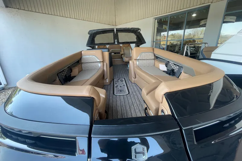 Slide: The Image of 2026 Harris Crowne SL 250 luxury boat interior with tan seating and sleek design. - 22
