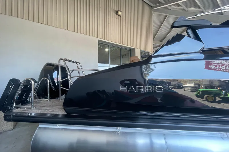 Slide: The Image of 2026 Harris Crowne SL 250 pontoon boat with Mercury engine in showroom. - 27