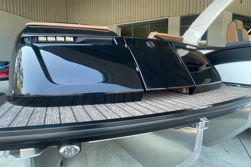Slide: The Image of 2026 Harris Crowne SL 250 boat with sleek black design and modern features. - 29