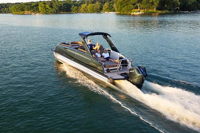 Slide: The Image of Manufacturer Provided Image: 2025 Harris Crowne SL 250 pontoon boat cruising on a scenic lake. - 3