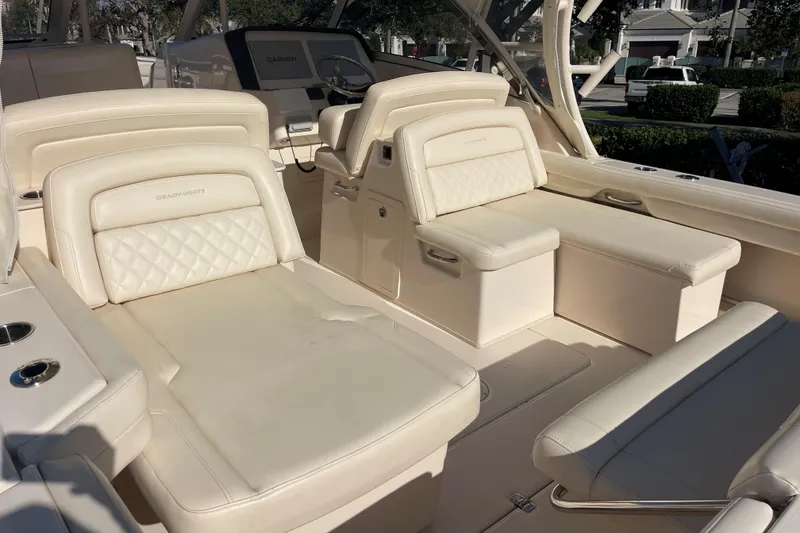 Slide: The Image of 2019 Grady-White Freedom 325 boat interior with luxurious cream seating and helm. - 11