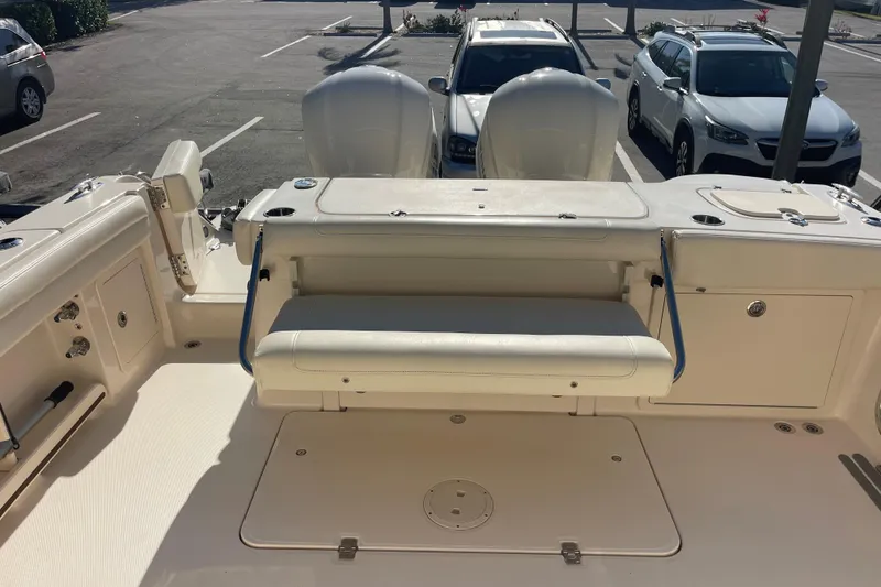 Slide: The Image of 2019 Grady-White Freedom 325 boat interior with seating and storage, parked in a lot. - 16