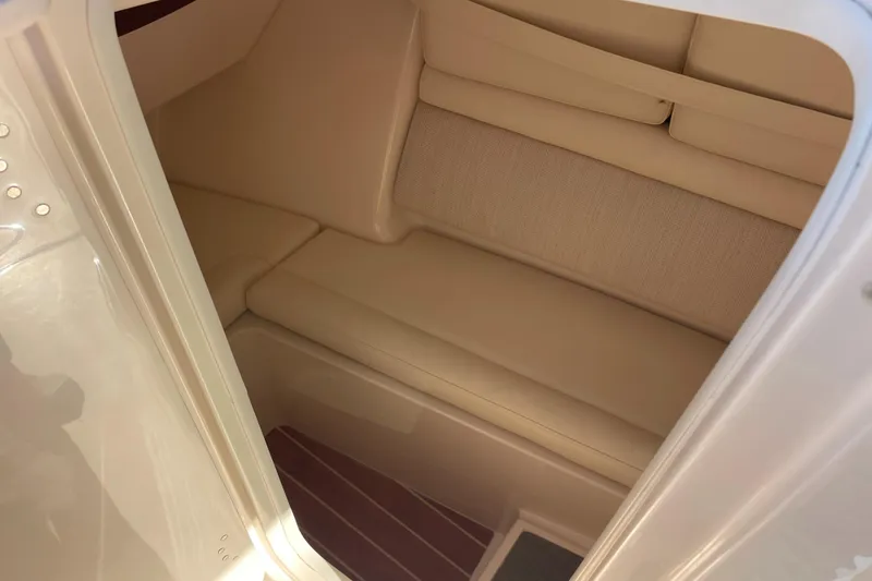 Slide: The Image of 2019 Grady-White Freedom 325 cabin interior with beige seating and wooden flooring. - 25