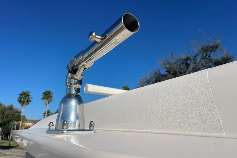 Slide: The Image of Close-up of a 2019 Grady-White Freedom 325 boat's rod holder against a clear blue sky. - 27