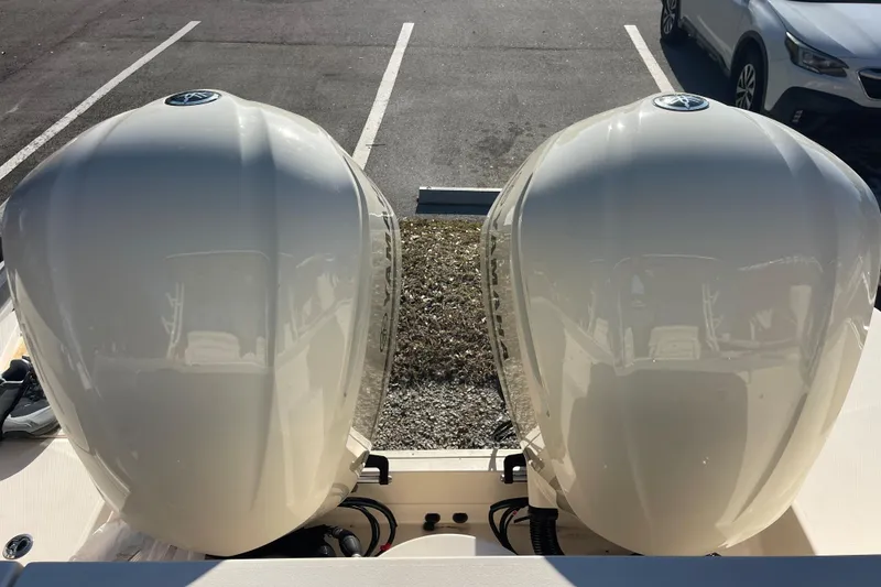 Slide: The Image of 2019 Grady-White Freedom 325 boat with dual outboard engines in a parking lot. - 28