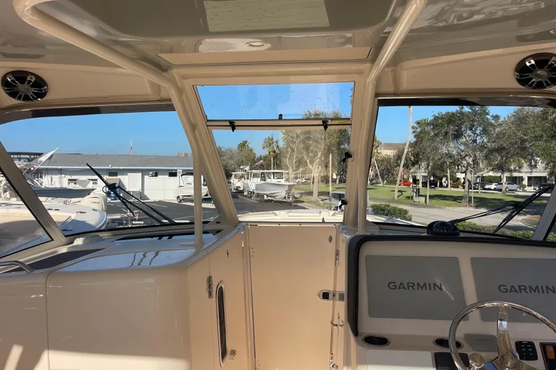 Slide: The Image of 2019 Grady-White Freedom 325 boat interior with Garmin navigation system, docked outdoors. - 3
