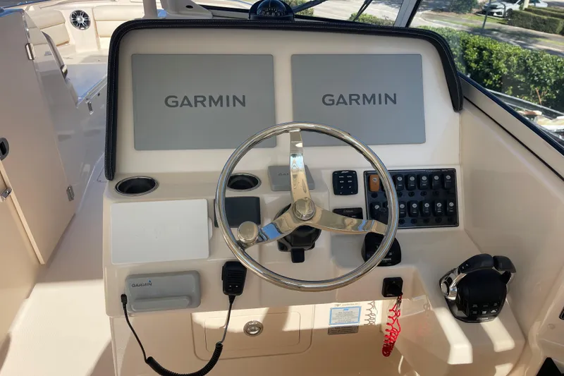 Slide: The Image of 2019 Grady-White Freedom 325 helm with Garmin displays and controls. - 4