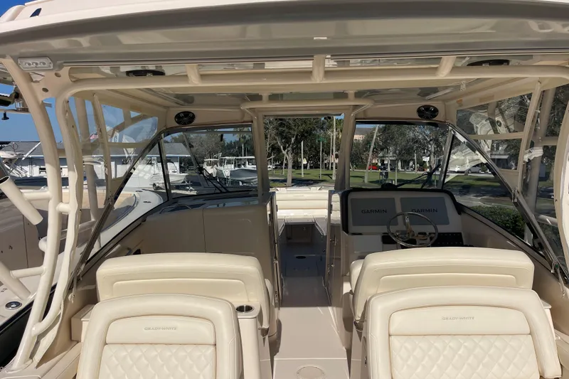 Slide: The Image of 2019 Grady-White Freedom 325 boat interior with Garmin navigation system and luxurious seating. - 7