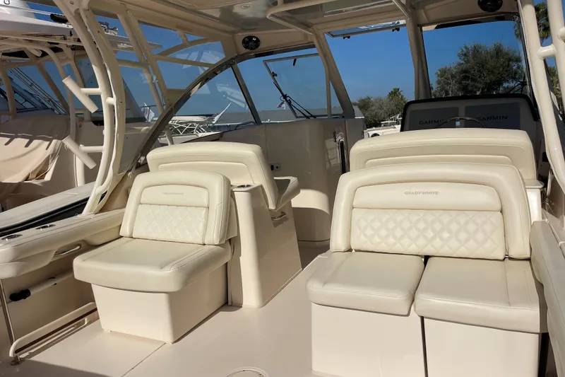 Slide: The Image of 2019 Grady-White Freedom 325 boat interior with cushioned seating and helm station. - 9