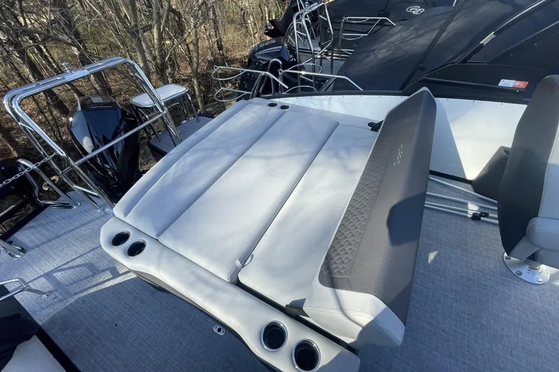 Slide: The Image of 2026 Harris Sunliner 230 boat interior with cushioned seating and cup holders. - 11