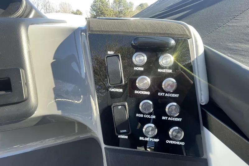 Slide: The Image of Control panel of 2026 Harris Sunliner 230 boat with various function buttons. - 15