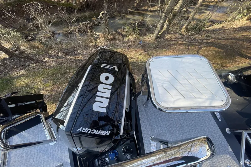 Slide: The Image of 2026 Harris Sunliner 230 with Mercury 250 V8 engine, parked near a stream. - 20