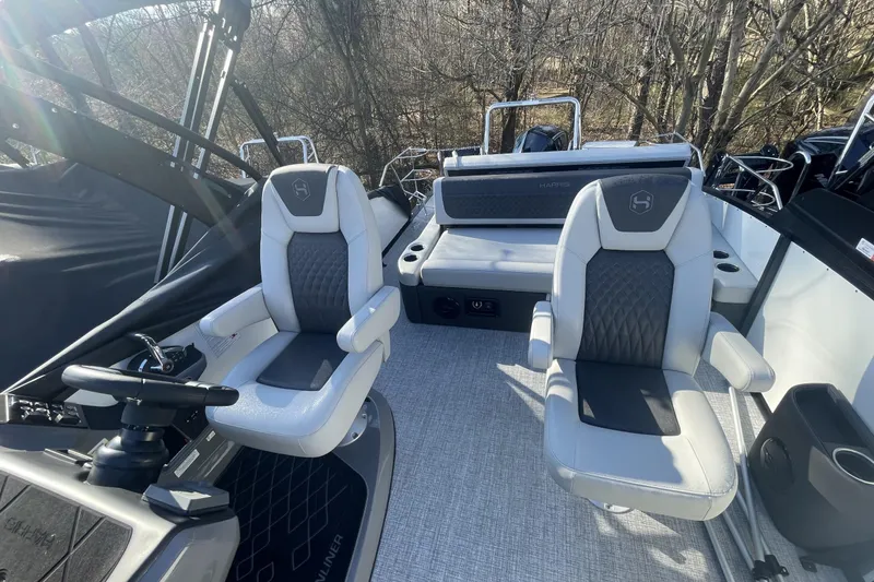 Slide: The Image of 2026 Harris Sunliner 230 boat interior with modern seating and steering wheel. - 5