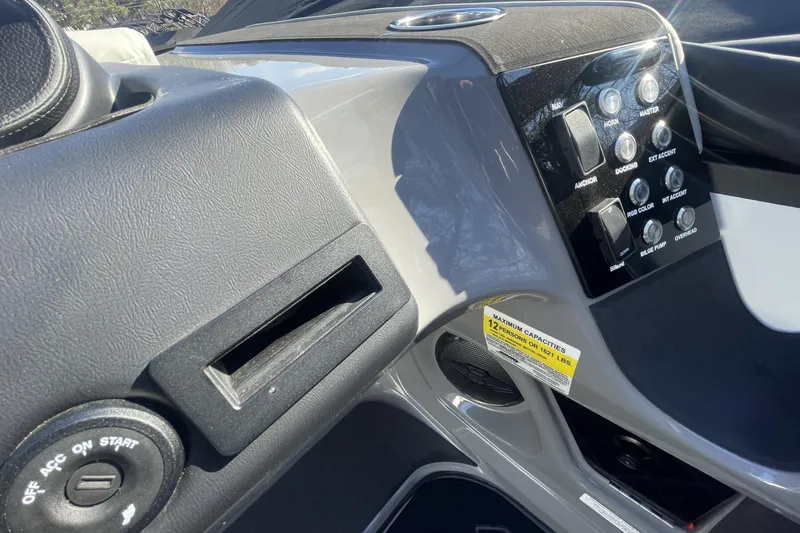 Slide: The Image of 2026 Harris Sunliner 230 dashboard with control panel and ignition switch. - 6