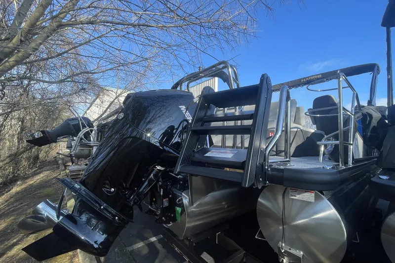 Slide: The Image of 2026 Harris Sunliner 230 pontoon boat with powerful Mercury outboard motor, under clear blue sky. - 9