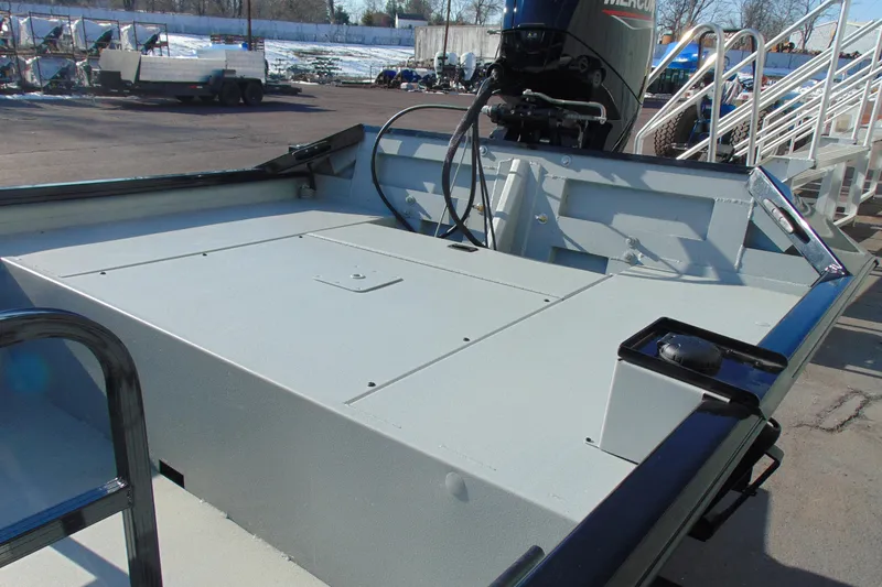 Slide: The Image of 2026 Crestliner 1760 Retriever SC boat with outboard motor, parked outdoors. - 11