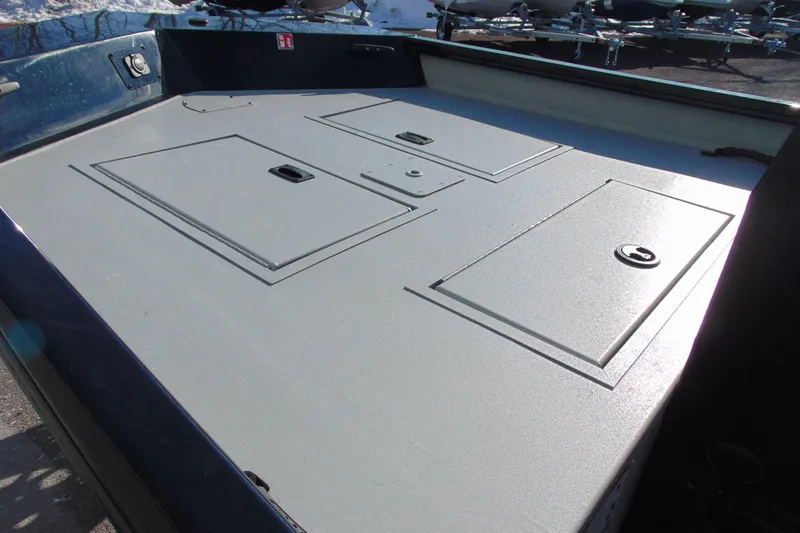 Slide: The Image of 2026 Crestliner 1760 Retriever SC boat deck with storage compartments. - 12