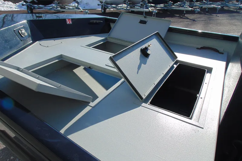 Slide: The Image of 2026 Crestliner 1760 Retriever SC boat storage compartments open on deck. - 13