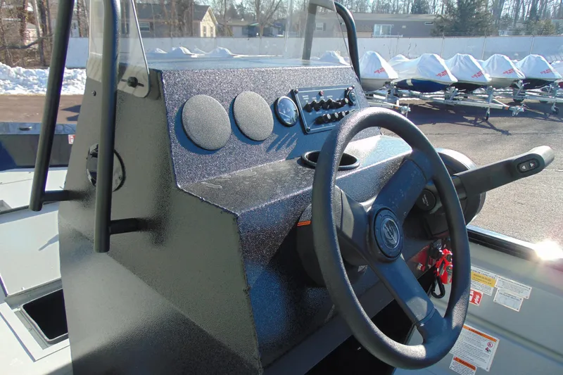 Slide: The Image of 2026 Crestliner 1760 Retriever SC boat console with steering wheel and controls. - 14