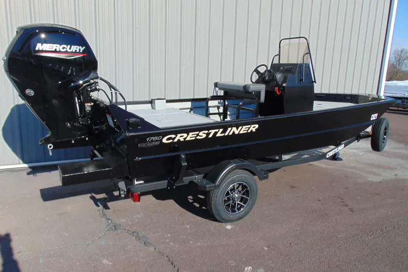 Slide: The Image of 2026 Crestliner 1760 Retriever SC boat with Mercury outboard motor, parked on trailer. - 3