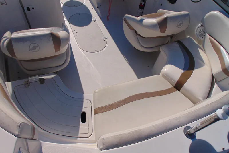 Slide: The Image of 2008 Starcraft 2210 OB Limited boat interior with beige seating and storage compartments. - 10