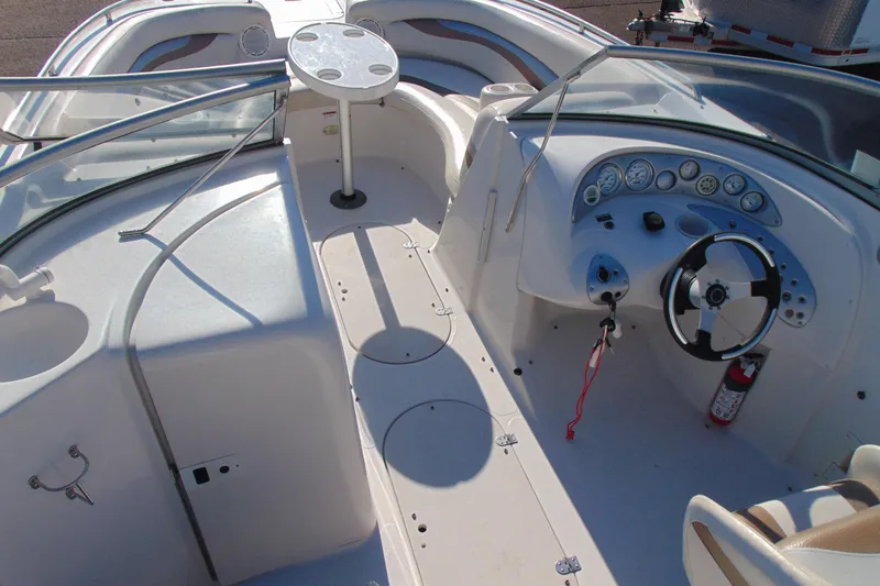 Slide: The Image of 2008 Starcraft 2210 OB Limited boat interior with steering wheel and seating area. - 11