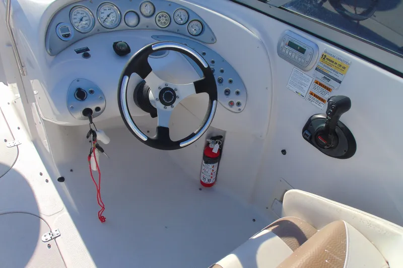 Slide: The Image of 2008 Starcraft 2210 OB Limited boat dashboard with steering wheel and controls. - 12