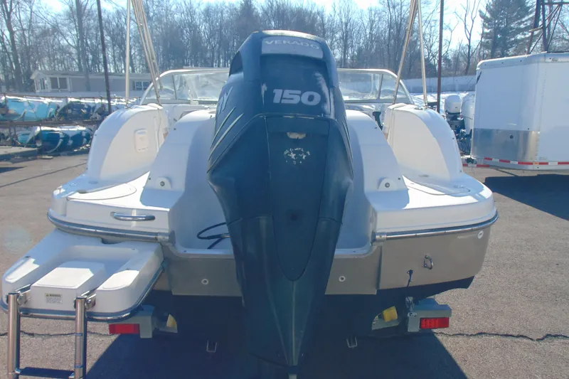 Slide: The Image of 2008 Starcraft 2210 OB Limited boat with 150 HP outboard motor, parked outdoors. - 5