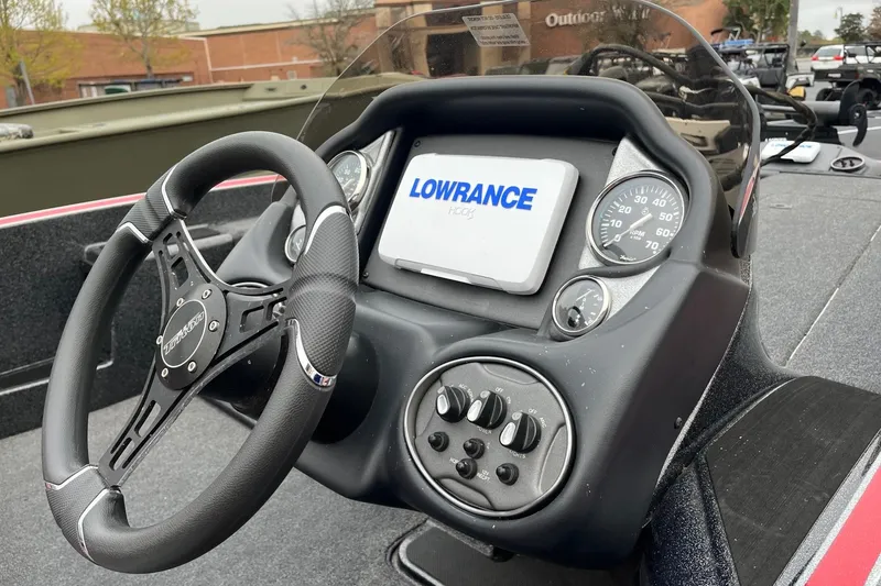 Slide: The Image of 2024 Triton 179 TrX boat dashboard with Lowrance display and steering wheel. - 5