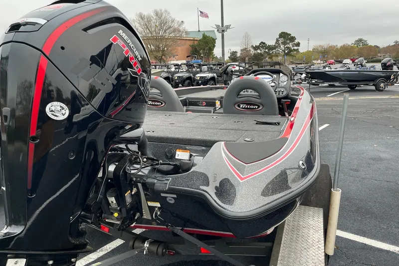 Slide: The Image of 2024 Triton 179 TrX boat with Mercury Pro engine in a parking lot. - 6