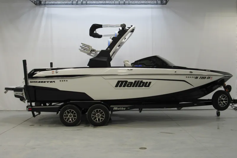 The Image of 2021 Malibu Wakesetter 23 LSV boat on trailer in showroom setting. - 0
