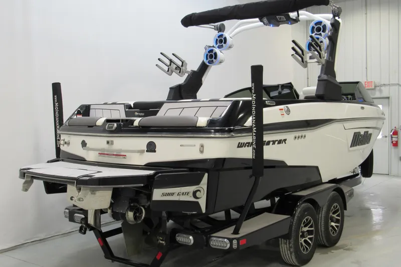 Slide: The Image of 2021 Malibu Wakesetter 23 LSV boat on trailer, featuring wakeboard tower and speakers. - 2