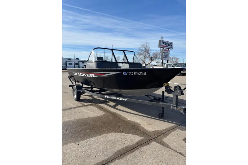 The Image of 2025 Tracker Pro Guide V-16 WT boat on trailer, parked outdoors. - 1
