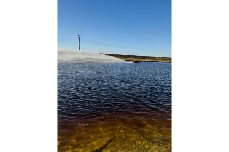 Slide: The Image of 1975 Sleekcraft Executive 23 speedboat gliding swiftly on a clear blue lake. - 10