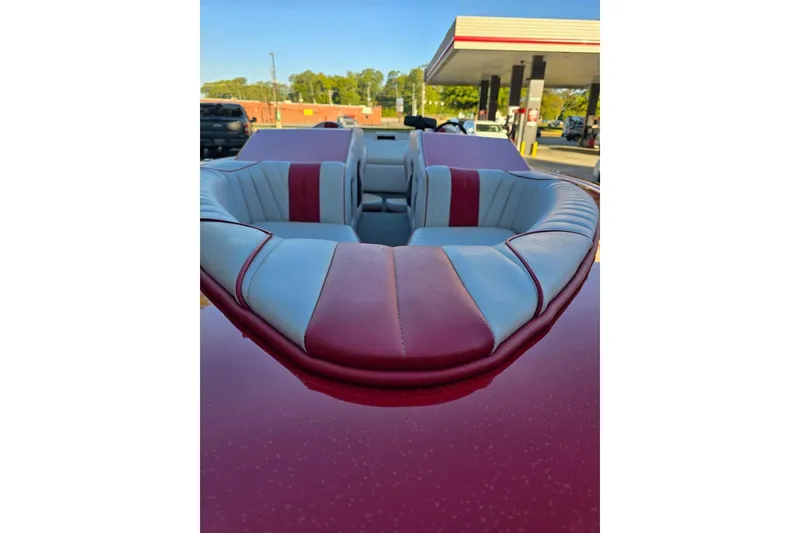Slide: The Image of 1975 Sleekcraft Executive 23 boat interior with red and white upholstery at a gas station. - 3